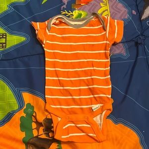 Orange onesie white strips and gray around the collar